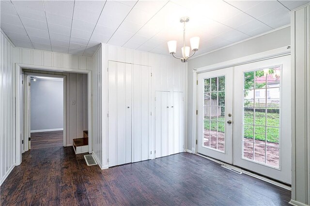 502 Vine St, Leavenworth, KS 66048 - unfurnished dining area with dark wood-style floors, french doors, a chandelier, and crown molding