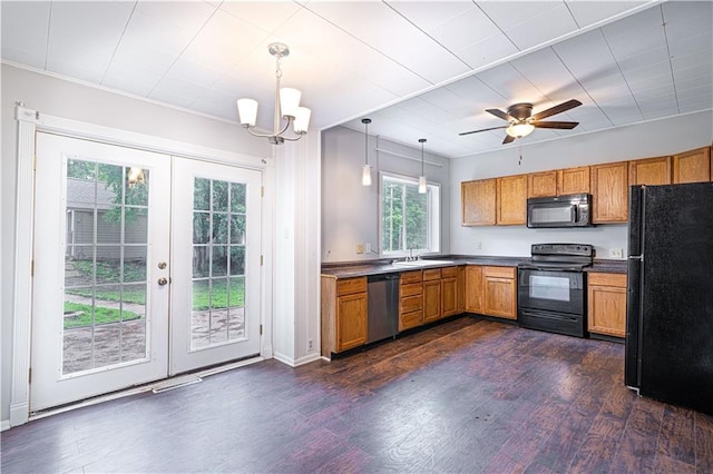502 Vine St, Leavenworth, KS 66048 - kitchen with black appliances, french doors, a sink, dark wood-style floors, and brown cabinetry