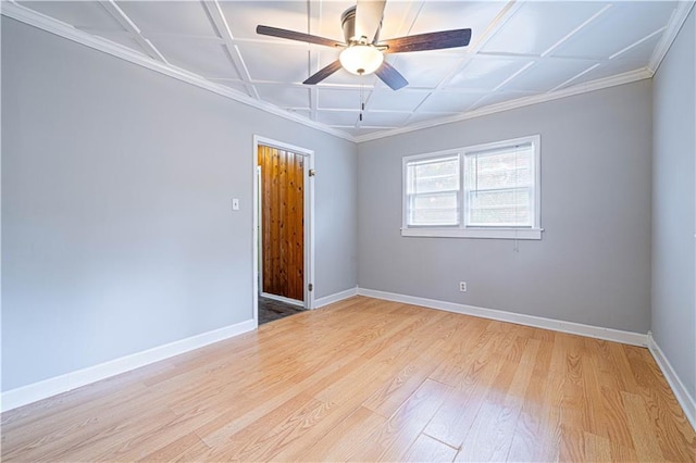 502 Vine St, Leavenworth, KS 66048 - empty room with light wood-style floors, a ceiling fan, baseboards, ornamental molding, and coffered ceiling