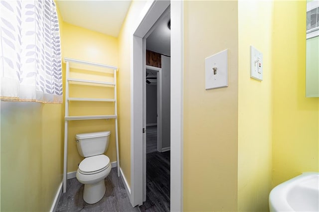 502 Vine St, Leavenworth, KS 66048 - half bathroom with toilet, wood finished floors, and baseboards