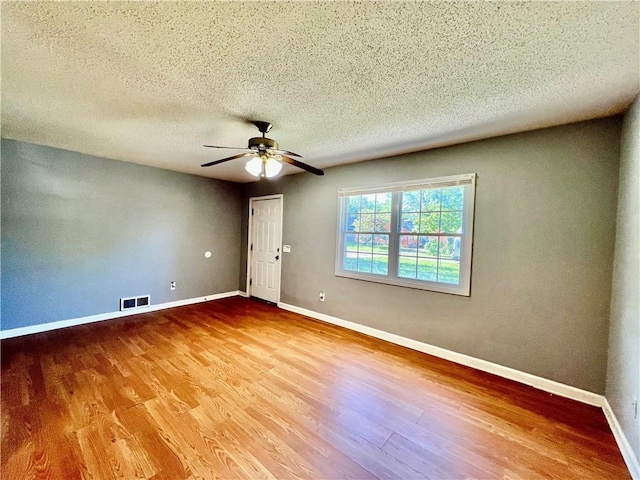 1208 E 80th St, Kansas City, MO 64131 - empty room featuring wood finished floors, a textured ceiling, ceiling fan, and baseboards