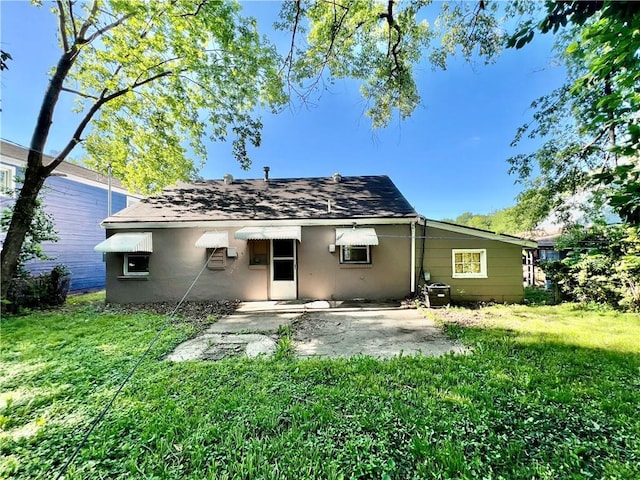 1208 E 80th St, Kansas City, MO 64131 - back of property featuring a patio area, stucco siding, a lawn, and roof with shingles