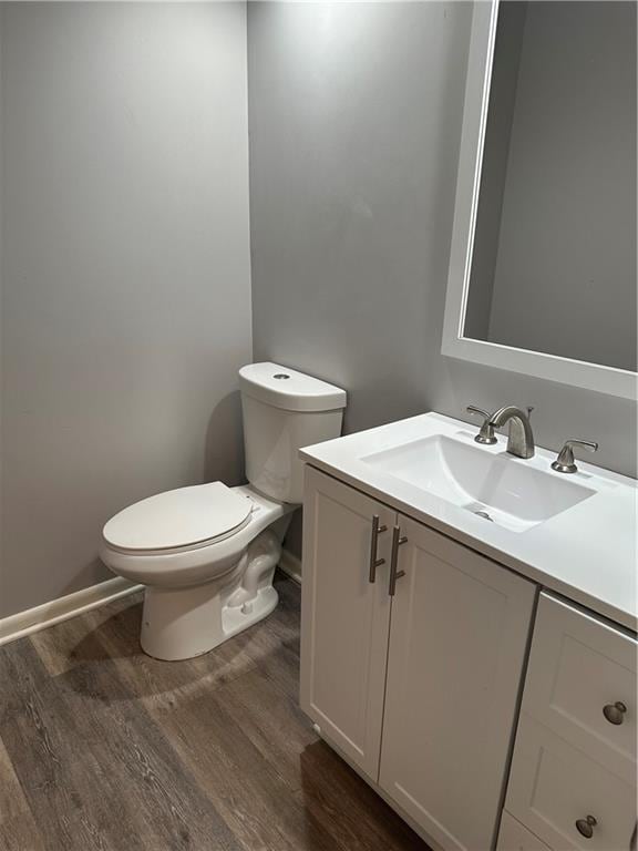 1220 N 76th Ter, Kansas City, KS 66112 - bathroom featuring wood finished floors, vanity, toilet, and baseboards
