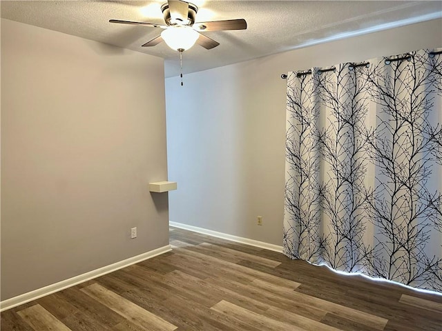 1220 N 76th Ter, Kansas City, KS 66112 - unfurnished room with a ceiling fan, wood finished floors, a textured ceiling, and baseboards