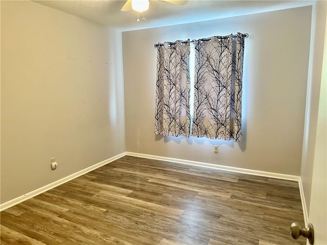 1220 N 76th Ter, Kansas City, KS 66112 - unfurnished room with a ceiling fan, wood finished floors, and baseboards