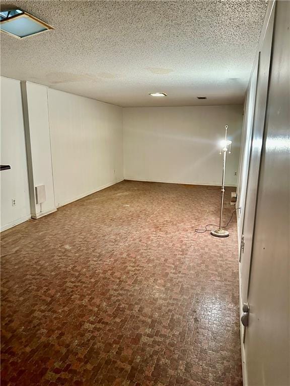 1220 N 76th Ter, Kansas City, KS 66112 - basement featuring brick patterned floors and a textured ceiling