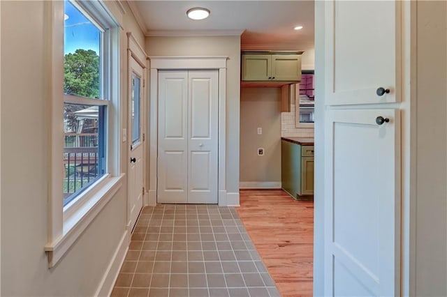 302 N Brighton Ave, Kansas City, MO 64123 - entryway with healthy amount of natural light, crown molding, baseboards, light wood-type flooring, and recessed lighting
