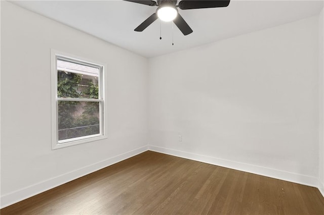5227 Highland Ave, Kansas City, MO 64110 - empty room featuring baseboards, dark wood-style flooring, and ceiling fan