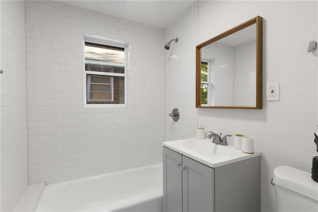 5227 Highland Ave, Kansas City, MO 64110 - bathroom with vanity, toilet, and washtub / shower combination