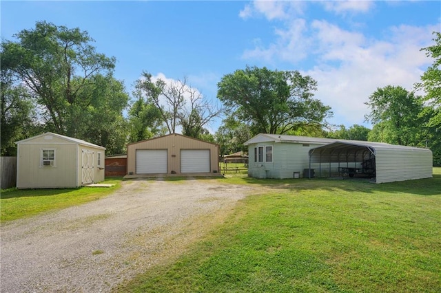707 Lake St S, Coffeyville, OK 74072 - detached garage with driveway and a shed