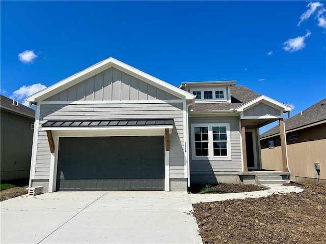 1516 SW Arborpark Ter, Lees Summit, MO 64082 - view of front of property featuring an attached garage, concrete driveway, roof with shingles, a standing seam roof, and board and batten siding