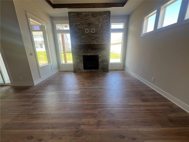 1516 SW Arborpark Ter, Lees Summit, MO 64082 - unfurnished living room featuring dark wood finished floors, baseboards, and a fireplace