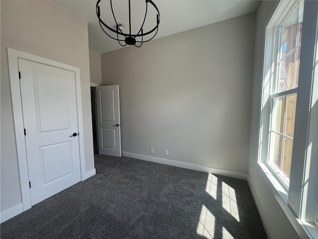 1516 SW Arborpark Ter, Lees Summit, MO 64082 - unfurnished room with dark carpet, a chandelier, and baseboards