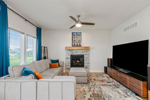 17756 Shady Bend Rd, Gardner, KS 66030 - living room featuring a ceiling fan, wood finished floors, a fireplace, and baseboards