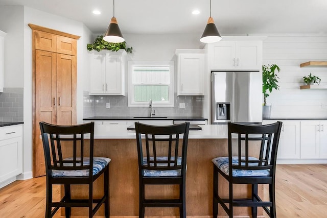 17756 Shady Bend Rd, Gardner, KS 66030 - kitchen featuring stainless steel fridge, a sink, backsplash, light wood finished floors, and recessed lighting