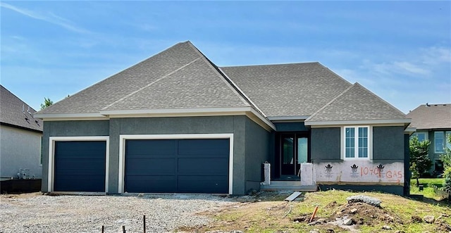 10401 W 151st Pl, Overland Park, KS 66221 - view of front of property featuring a garage, stucco siding, a shingled roof, and gravel driveway
