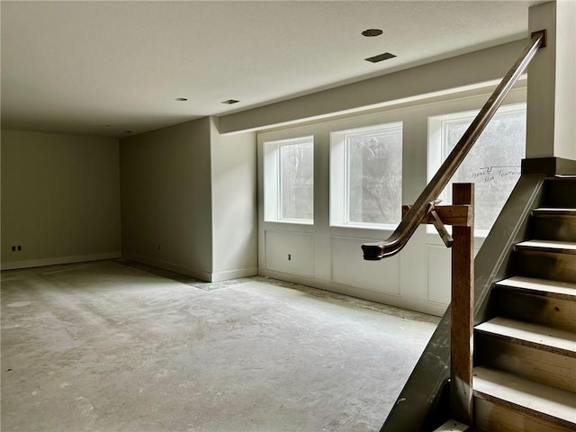 10401 W 151st Pl, Overland Park, KS 66221 - unfurnished room with stairway, unfinished concrete floors, and plenty of natural light