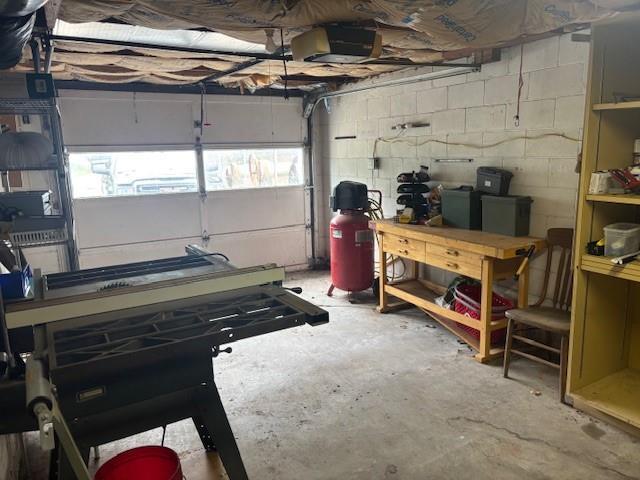 1119 Mound St, Atchison, KS 66002 - garage with concrete block wall and a workshop area
