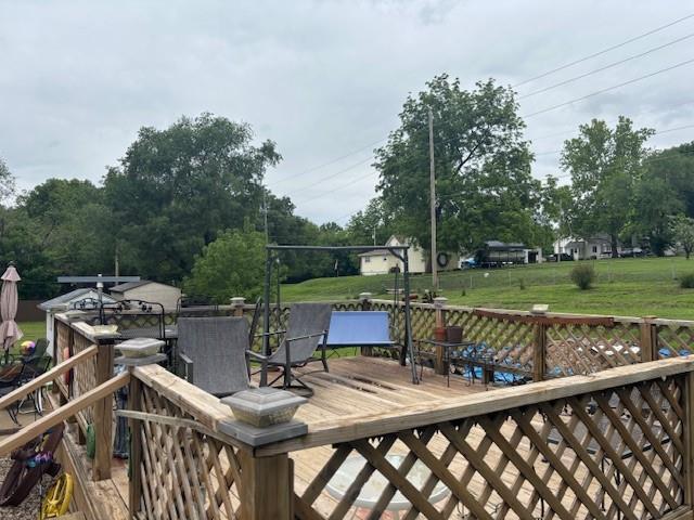 1119 Mound St, Atchison, KS 66002 - deck featuring outdoor dining space and a yard