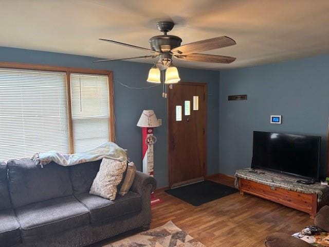 1119 Mound St, Atchison, KS 66002 - living area with ceiling fan, wood finished floors, plenty of natural light, and baseboards