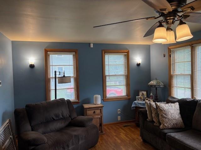 1119 Mound St, Atchison, KS 66002 - living room with a ceiling fan, wood finished floors, healthy amount of natural light, and baseboards