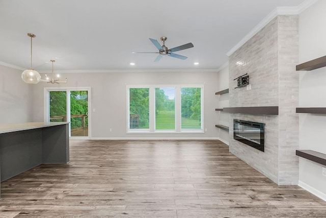7515 Locust Dr, Kansas City, MO 64152 - unfurnished living room featuring healthy amount of natural light, wood finished floors, ceiling fan, a brick fireplace, and crown molding