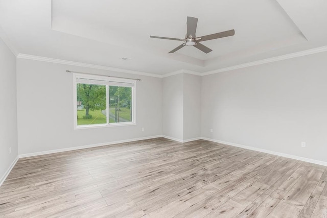 7515 Locust Dr, Kansas City, MO 64152 - spare room with a raised ceiling, light wood-style floors, ceiling fan, baseboards, and crown molding