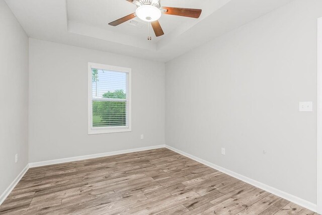 7515 Locust Dr, Kansas City, MO 64152 - unfurnished room with a raised ceiling, wood finished floors, baseboards, and ceiling fan