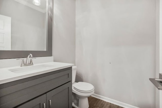 7515 Locust Dr, Kansas City, MO 64152 - half bathroom featuring toilet, wood finished floors, ornamental molding, vanity, and baseboards