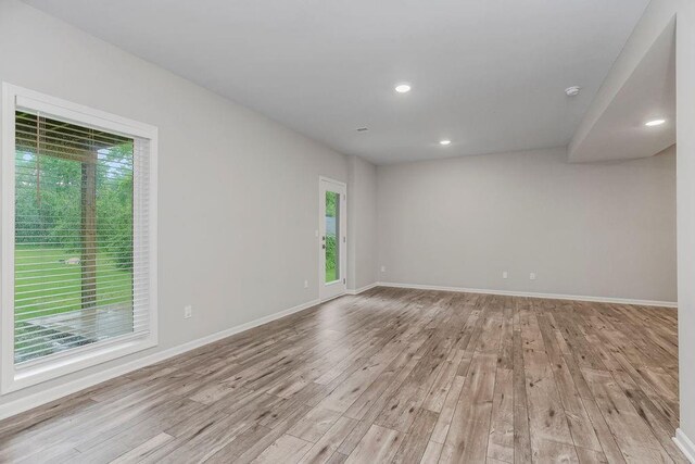 7515 Locust Dr, Kansas City, MO 64152 - unfurnished room with healthy amount of natural light, light wood-type flooring, baseboards, recessed lighting, and a smoke detector