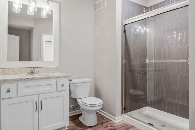 7515 Locust Dr, Kansas City, MO 64152 - full bath with toilet, wood finished floors, vanity, and a stall shower
