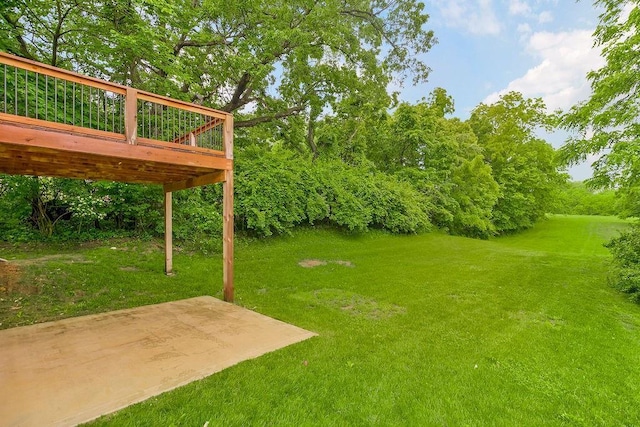 7515 Locust Dr, Kansas City, MO 64152 - view of grassy yard with a patio, a wooden deck, and view of wooded area