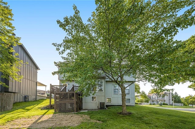8901 W 128th St, Overland Park, KS 66213 - back of house featuring a yard, a wooden deck, and board and batten siding