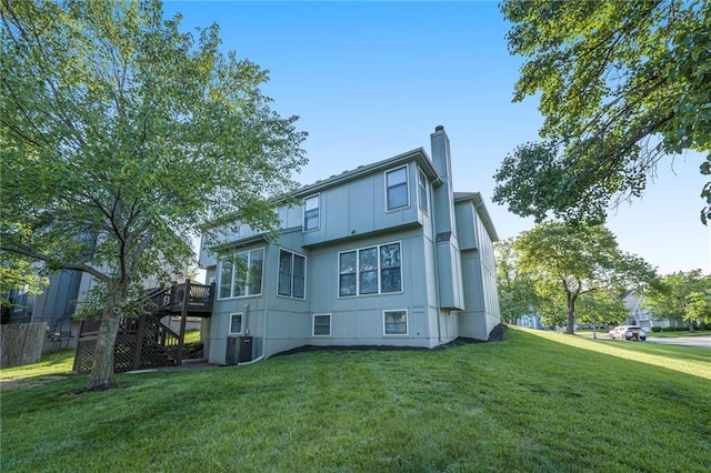8901 W 128th St, Overland Park, KS 66213 - back of house featuring stairway, a deck, a yard, and a chimney