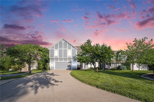 8901 W 128th St, Overland Park, KS 66213 - tudor house featuring concrete driveway, a garage, a yard, and stucco siding