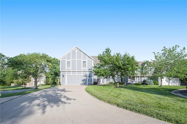 8901 W 128th St, Overland Park, KS 66213 - tudor-style house with concrete driveway, an attached garage, a front lawn, and stucco siding