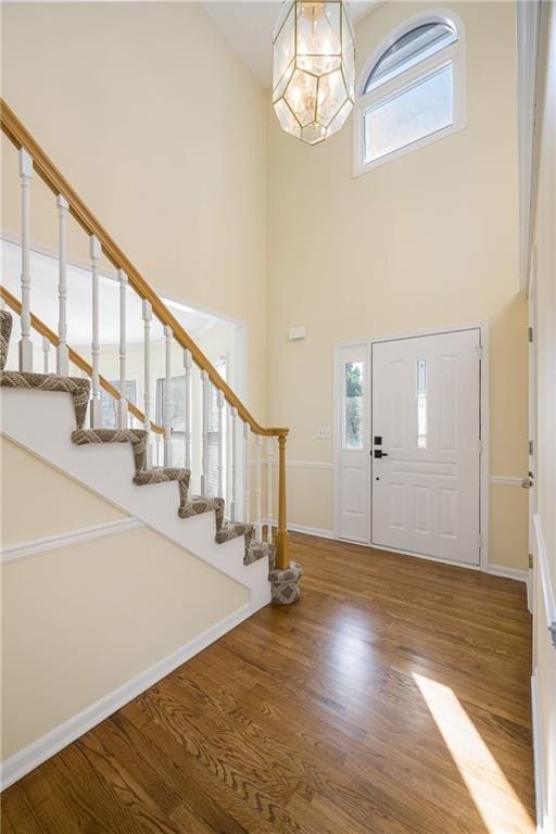 8901 W 128th St, Overland Park, KS 66213 - entryway featuring a towering ceiling, stairs, a chandelier, and healthy amount of natural light