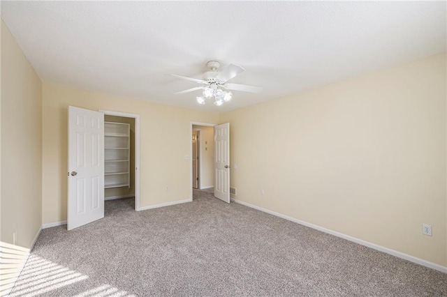 8901 W 128th St, Overland Park, KS 66213 - unfurnished bedroom with carpet floors, a spacious closet, ceiling fan, baseboards, and a closet