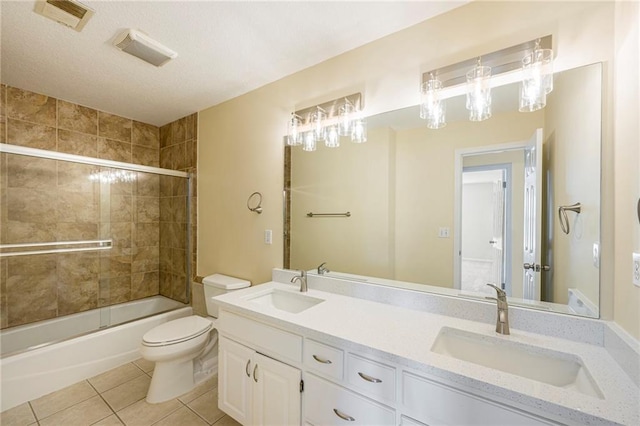 8901 W 128th St, Overland Park, KS 66213 - full bath with toilet, double vanity, tile patterned flooring, and shower / bath combination with glass door