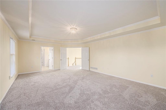 8901 W 128th St, Overland Park, KS 66213 - carpeted spare room featuring a raised ceiling, ornamental molding, and baseboards