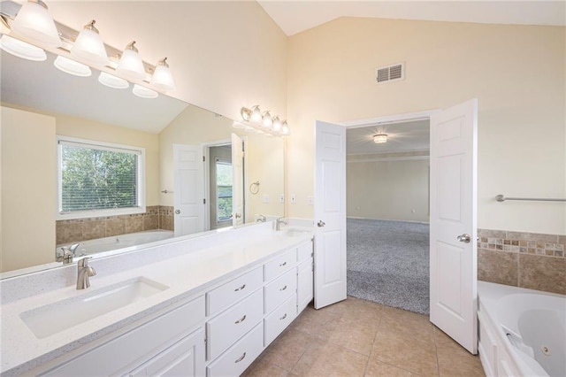 8901 W 128th St, Overland Park, KS 66213 - bathroom featuring a jetted tub, double vanity, tile patterned floors, and high vaulted ceiling