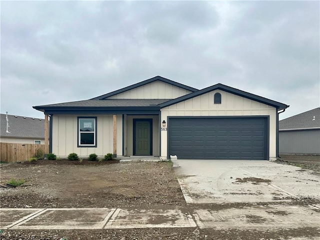 563 N Pecan St, Gardner, KS 66030 - ranch-style house featuring driveway, a garage, board and batten siding, and a shingled roof
