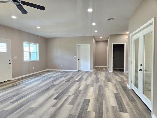 1101 Lakewood Dr, Pittsburg, KS 66762 - unfurnished living room with french doors, wood finished floors, baseboards, ceiling fan, and recessed lighting