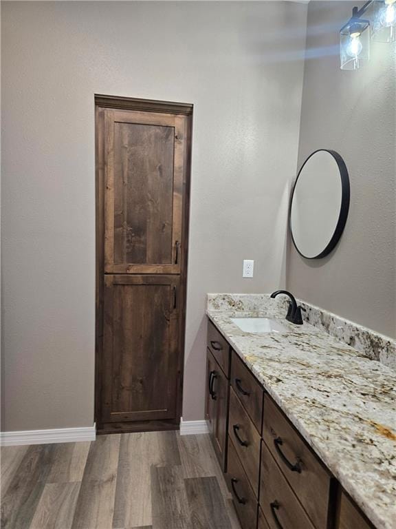 1101 Lakewood Dr, Pittsburg, KS 66762 - bathroom featuring wood finished floors, vanity, and baseboards