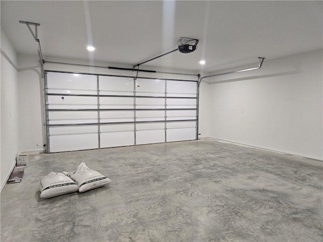 1101 Lakewood Dr, Pittsburg, KS 66762 - garage featuring a garage door opener and baseboards