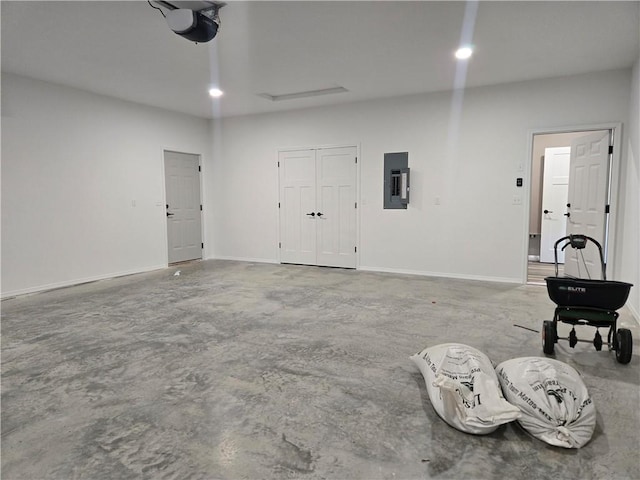 1101 Lakewood Dr, Pittsburg, KS 66762 - garage with electric panel, a garage door opener, and baseboards