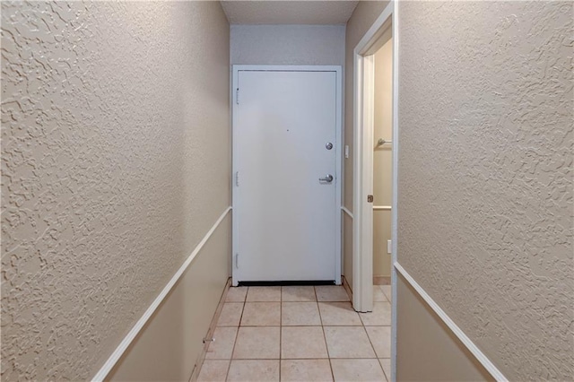 4157 Roanoke Rd Unit 2, Kansas City, MO 64111 - corridor with a textured wall and light tile patterned floors