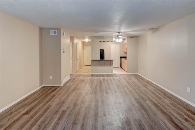 4157 Roanoke Rd Unit 2, Kansas City, MO 64111 - unfurnished living room featuring a ceiling fan, light wood-type flooring, and baseboards