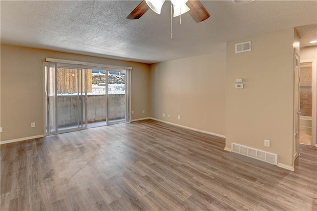 4157 Roanoke Rd Unit 2, Kansas City, MO 64111 - empty room featuring a ceiling fan, wood finished floors, a textured ceiling, and baseboards