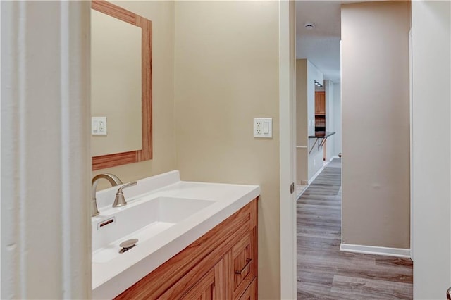 4157 Roanoke Rd Unit 2, Kansas City, MO 64111 - bathroom with wood finished floors, vanity, and baseboards